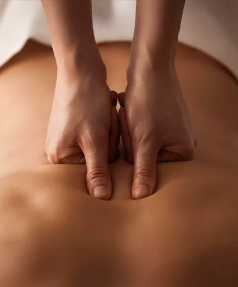 Manual therapeutic pressure applied to the back